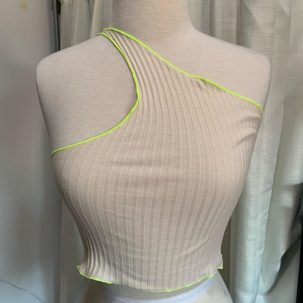 One shoulder cream crop top neon green lining.